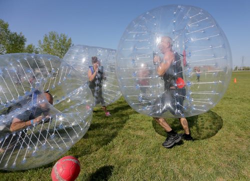 Neil Trudeau, right, runs River City Bubble Ball, a company that organizes bubble soccer, Saturday, May 23, 2015. (TREVOR HAGAN/WINNIPEG FREE PRESS) - for dave sanderson intersection 49.9 piece