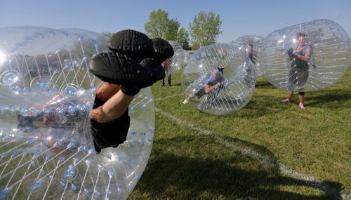 Neil Trudeau, left, runs River City Bubble Ball, a company that organizes bubble soccer, Saturday, May 23, 2015. (TREVOR HAGAN/WINNIPEG FREE PRESS) - for dave sanderson intersection 49.9 piece