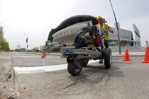 49.8 - Road lines being painted by a City of Winnipeg crews on University Crescent near the stadium. Painter is Denis Bouchard. BORIS MINKEVICH/WINNIPEG FREE PRESS May 25, 2015