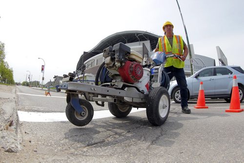 49.8 - Road lines being painted by a City of Winnipeg crews on University Crescent near the stadium. Painter is Denis Bouchard. BORIS MINKEVICH/WINNIPEG FREE PRESS May 25, 2015