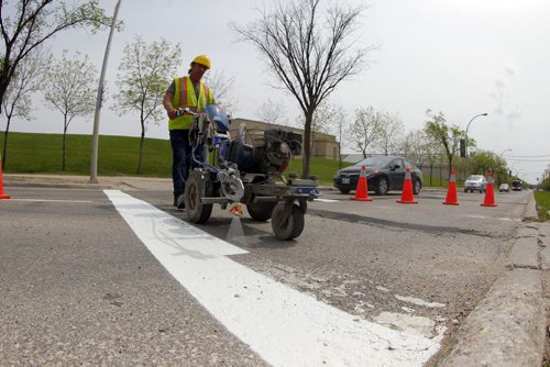 49.8 - Road lines being painted by a City of Winnipeg crews on University Crescent near the stadium. Painter is Denis Bouchard.  BORIS MINKEVICH/WINNIPEG FREE PRESS May 25, 2015