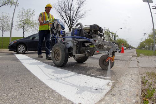 49.8 - Road lines being painted by a City of Winnipeg crews on University Crescent near the stadium. Painter is Denis Bouchard.  BORIS MINKEVICH/WINNIPEG FREE PRESS May 25, 2015