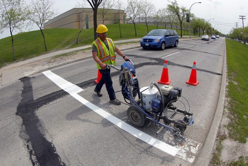 49.8 - Road lines being painted by a City of Winnipeg crews on University Crescent near the stadium. Painter is Denis Bouchard.  BORIS MINKEVICH/WINNIPEG FREE PRESS May 25, 2015