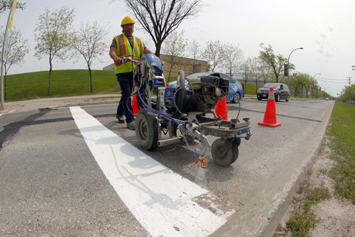 49.8 - Road lines being painted by a City of Winnipeg crews on University Crescent near the stadium. Painter is Denis Bouchard.  BORIS MINKEVICH/WINNIPEG FREE PRESS May 25, 2015