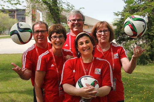FIFA Volunteers- left to right- Barry and Carol McArton, Stephen Bubnowicz, Catherine Babb and Maria Albi (front centre) pose monday with their new shirts and FIFA soccer balls Monday. See Melissa Martin's story.  May 25, 2015 - (Phil Hossack / Winnipeg Free Press)