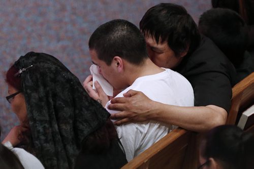 May 25, 2015 - 150525  -  Teresa Robinson's brother is comforted by his father at a memorial service. Friends and family came together to celebrate the life of Teresa Robinson at Calvary Temple Monday, May 25, 2015. John Woods / Winnipeg Free Press