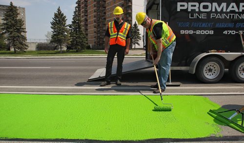 Crews from the City of Winnipeg and Promark Line Painting were on hand along Pembina Highway Tuesday afternoon for a demonstration by Ennis-Flint a traffic safety solutions company as they applied a green methyl methacrylate (MMA) or durable pavement marking to highlight the bicycle path.  150526 May 26, 2015 Mike Deal / Winnipeg Free Press