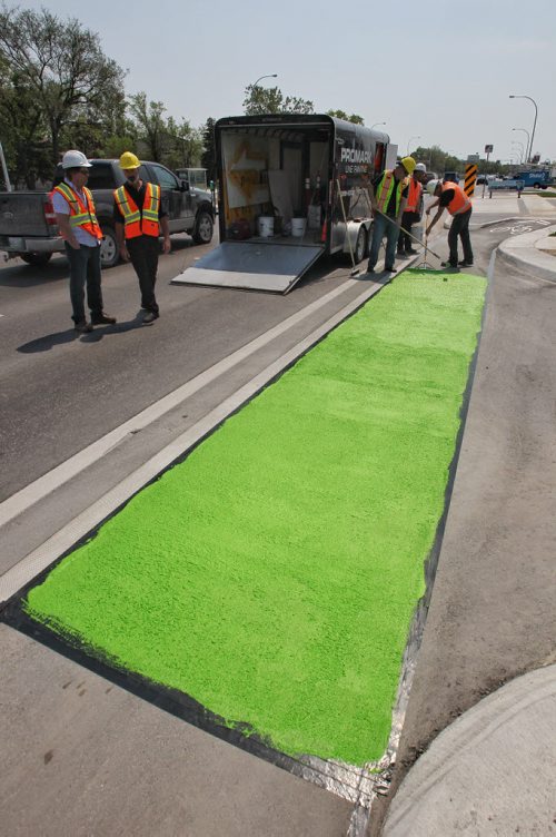 Crews from the City of Winnipeg and Promark Line Painting were on hand along Pembina Highway Tuesday afternoon for a demonstration by Ennis-Flint a traffic safety solutions company as they applied a green methyl methacrylate (MMA) or durable pavement marking to highlight the bicycle path.  150526 May 26, 2015 Mike Deal / Winnipeg Free Press