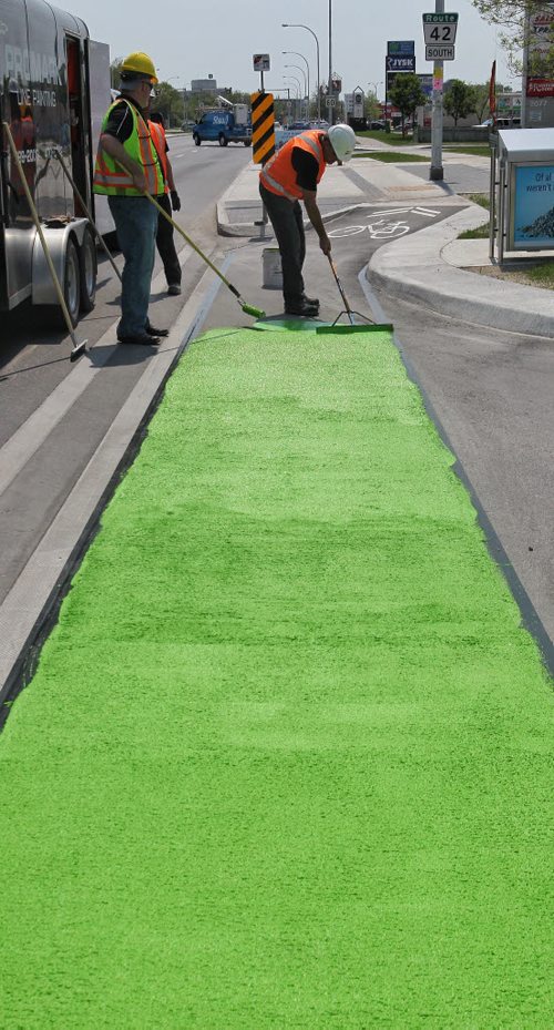 Crews from the City of Winnipeg and Promark Line Painting were on hand along Pembina Highway Tuesday afternoon for a demonstration by Ennis-Flint a traffic safety solutions company as they applied a green methyl methacrylate (MMA) or durable pavement marking to highlight the bicycle path.  150526 May 26, 2015 Mike Deal / Winnipeg Free Press