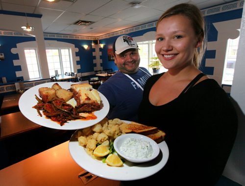 Chef David Capone and server Tegan Davies hold the Moussaka and Calamari respectively at the the dining room at the Olympia Diner. See Marion Warhaft's review. May26, 2015 - (Phil Hossack / Winnipeg Free Press)