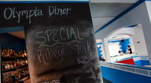 A large chalkboard menu leads guest past the front door into the dining room at Olympia Diner. See Marion Warhaft's review. May26, 2015 - (Phil Hossack / Winnipeg Free Press)