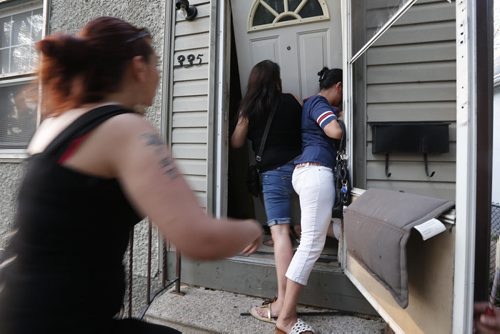 May 26, 2015 - 140526  -  Some family supporters break through a door of a home on Aberdeen where they suspected Shanastene McLeod is being held. On Tuesday, May 26, 2015 community members came out to support the family of Shanastene McLeod who has gone missing and is allegedly being pimped out in a North End home.  John Woods / Winnipeg Free Press
