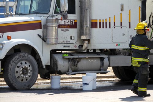 A semi's fuel tank was smashed and leaks out on Archibald Street just north of Plinguit Street in St. Boniface. Fire crews use pails to catch the fuel as it comes out on the street. No injuries reported at the time. Manitoba Environment was notified. Haz Mat unit was dispatched to the scene. BORIS MINKEVICH/WINNIPEG FREE PRESS May 27, 2015