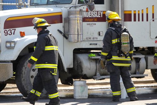 A semi's fuel tank was smashed and leaks out on Archibald Street just north of Plinguit Street in St. Boniface. Fire crews use pails to catch the fuel as it comes out on the street. No injuries reported at the time. Manitoba Environment was notified. Haz Mat unit was dispatched to the scene. BORIS MINKEVICH/WINNIPEG FREE PRESS May 27, 2015
