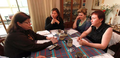 Left to right, Gulhiyaz (from Kazakstan) Svitlana (from Crimea)  and Halyna (from Ukraine)  work around an apartment table with Barbara Cansino a volunteer ESL instructor. All these students are medical doctors brusing up their english to bring medical qualifications to Canadian standards. See Carol Sanders story. May 27, 2015 - (Phil Hossack / Winnipeg Free Press) CAROL HAS FULL NAMES.
