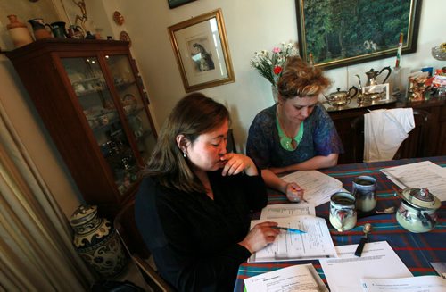 Left to right, Gulhiyaz Abisheva and Halyna Fymyla ponder an english puzzle at Barbara Cansino's home. Doctor students  brushing up their english to bring their medical qualifications to Canadian standards. See Carol Sanders story. May 27, 2015 - (Phil Hossack / Winnipeg Free Press) CAROL HAS FULL NAMES.