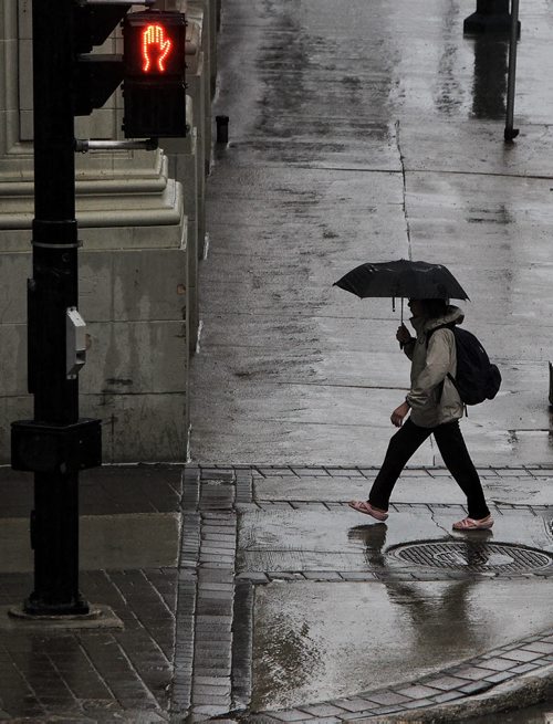 Pedestrians bring out their umbrellas downtown as the forecast is for a steady rain for most of the day.  150528 May 28, 2015 Mike Deal / Winnipeg Free Press