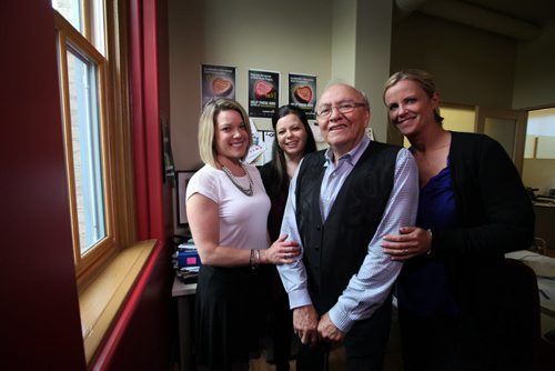 Theodore Fontaine with Canadian Centre for Child Protection staff - Christy Dzikowicz (right), Avery Wolaniuk (centre) and Kaleigh Hamilton in Fontaine's former residential school classroom.   Theodore Fontaine, attends the former Assiniboine Residential School ( Assiniboia Residential School) at 611 Academy that he went to in the late 1950's, now it is, ironically, the Canadian Centre for Child Protection. Fontaine spends  time looking out the window of his former classroom and on the stairwell he climbed many times while attending the school. and perusing a archival class photo with him and his classmates  from 1958. See Catherine Mitchell story.   May 28, 2015 Ruth Bonneville / Winnipeg Free Press