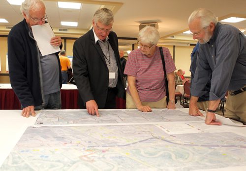 Residents were invited to attend a public information session to view the functional design of Stage 2 of the Southwest Transitway, the extension from Jubilee Avenue to the University of Manitoba. Second from left, Engineer Dave Krahn of Dillon Consulting explains some plans to some people that  came to the event. BORIS MINKEVICH/WINNIPEG FREE PRESS May 28, 2015