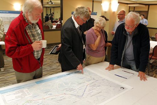 Residents were invited to attend a public information session to view the functional design of Stage 2 of the Southwest Transitway, the extension from Jubilee Avenue to the University of Manitoba. Second from left, Engineer Dave Krahn of Dillon Consulting explains some plans to some people that  came to the event. BORIS MINKEVICH/WINNIPEG FREE PRESS May 28, 2015