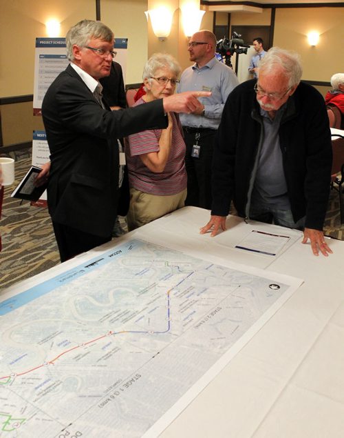 Residents were invited to attend a public information session to view the functional design of Stage 2 of the Southwest Transitway, the extension from Jubilee Avenue to the University of Manitoba. Left, Engineer Dave Krahn of Dillon Consulting explains some plans to some people that  came to the event. BORIS MINKEVICH/WINNIPEG FREE PRESS May 28, 2015