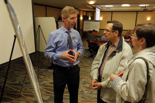 Residents were invited to attend a public information session to view the functional design of Stage 2 of the Southwest Transitway, the extension from Jubilee Avenue to the University of Manitoba at the Canad Inns on Pembina Highway. Rapid Transit's Scott Payne,left,  talks to some Winnipeg residents. BORIS MINKEVICH/WINNIPEG FREE PRESS May 28, 2015