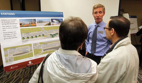 Residents were invited to attend a public information session to view the functional design of Stage 2 of the Southwest Transitway, the extension from Jubilee Avenue to the University of Manitoba at the Canad Inns on Pembina Highway. Rapid Transit's Scott Payne,left,  talks to some Winnipeg residents. BORIS MINKEVICH/WINNIPEG FREE PRESS May 28, 2015