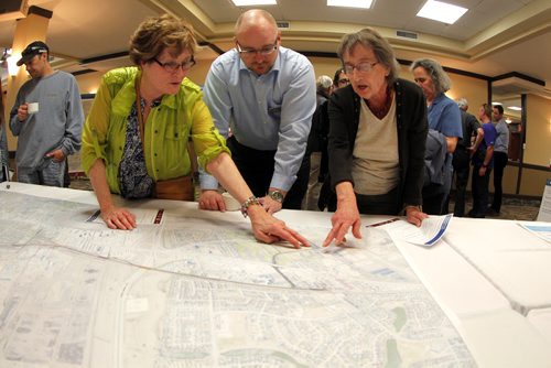 Residents were invited to attend a public information session to view the functional design of Stage 2 of the Southwest Transitway, the extension from Jubilee Avenue to the University of Manitoba at the Canad Inns on Pembina Highway. Centre, Björn Rådström from Rapid transit takes questions and listens to some area residents. BORIS MINKEVICH/WINNIPEG FREE PRESS May 28, 2015