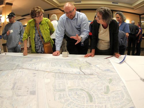 Residents were invited to attend a public information session to view the functional design of Stage 2 of the Southwest Transitway, the extension from Jubilee Avenue to the University of Manitoba at the Canad Inns on Pembina Highway. Centre, Björn Rådström from Rapid transit takes questions and listens to some area residents. BORIS MINKEVICH/WINNIPEG FREE PRESS May 28, 2015