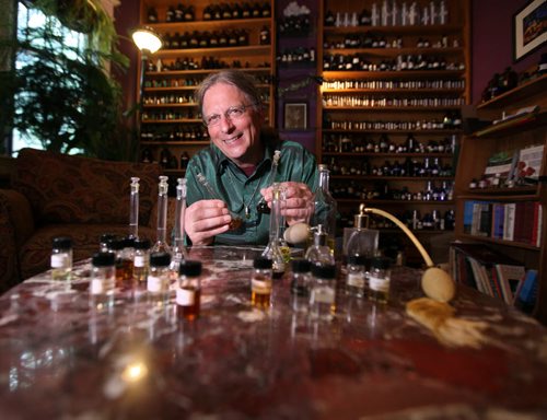 Michael O'Malley is all smiles as he blends essential oils in his home studio on Evanson st. Thursday after winning fight against City Hall to close his walk-in business down. See story.   May 28, 2015 Ruth Bonneville / Winnipeg Free Press