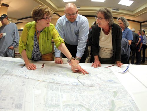 Residents were invited to attend a public information session to view the functional design of Stage 2 of the Southwest Transitway, the extension from Jubilee Avenue to the University of Manitoba at the Canad Inns on Pembina Highway. Centre, Björn Rådström from Rapid transit takes questions and listens to (L) Wendy Wylie and (R) Grace Rempel, some area residents. BORIS MINKEVICH/WINNIPEG FREE PRESS May 28, 2015