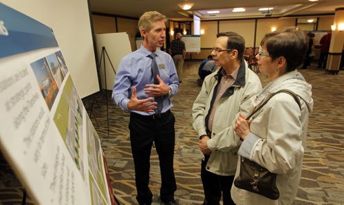 Residents were invited to attend a public information session to view the functional design of Stage 2 of the Southwest Transitway, the extension from Jubilee Avenue to the University of Manitoba at the Canad Inns on Pembina Highway. Rapid Transit's Scott Payne,left,  talks to some brother and sister Dennis and Pat Potoroka, Winnipeg residents. BORIS MINKEVICH/WINNIPEG FREE PRESS May 28, 2015