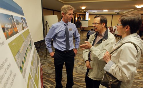 Residents were invited to attend a public information session to view the functional design of Stage 2 of the Southwest Transitway, the extension from Jubilee Avenue to the University of Manitoba at the Canad Inns on Pembina Highway. Rapid Transit's Scott Payne,left,  talks to some brother and sister Dennis and Pat Potoroka, Winnipeg residents. BORIS MINKEVICH/WINNIPEG FREE PRESS May 28, 2015