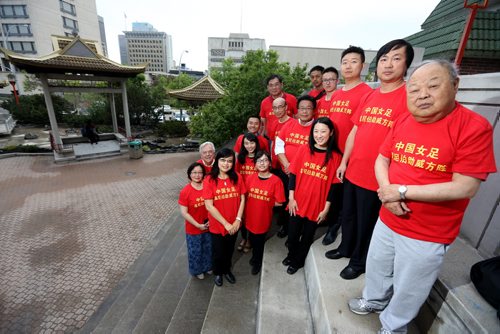 Members of the board of the Winnipeg Chinese Canadian Culrtural Centre wearing shirts they've made to support Team China in the upcoming FIFA Women's World Cup, Thursday, May 28, 2015. (TREVOR HAGAN/WINNIPEG FREE PRESS)