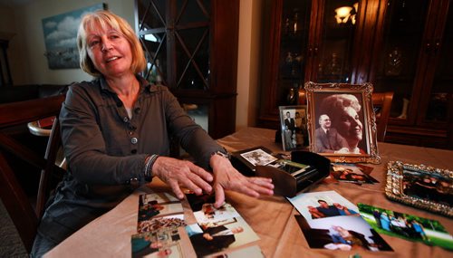 Her hands hovering over snapshot memories of her father, Joanne Rislund recalls memories good and bad about Frank ALexander an Alziemer's patient who was killed by another senior in a Winnipeg Nursing home.See Carol Sanders post enquiry story. May 28, 2015 - (Phil Hossack / Winnipeg Free Press)