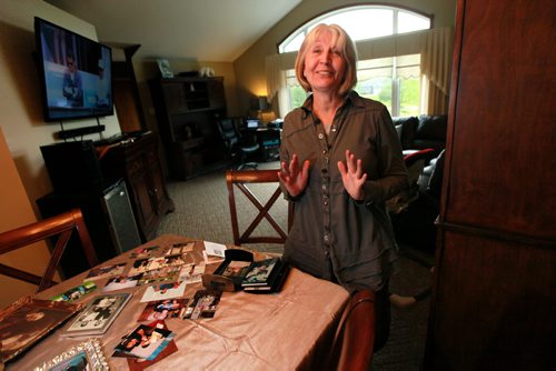 Standing at her dining room table covered in snapshots, Joanne Rislund recalls memories good and bad about her father Frank ALexander, an Alziemer's patient killed by another senior in a Winnipeg Nursing home.See Carol Sanders post enquiry story. May 28, 2015 - (Phil Hossack / Winnipeg Free Press)