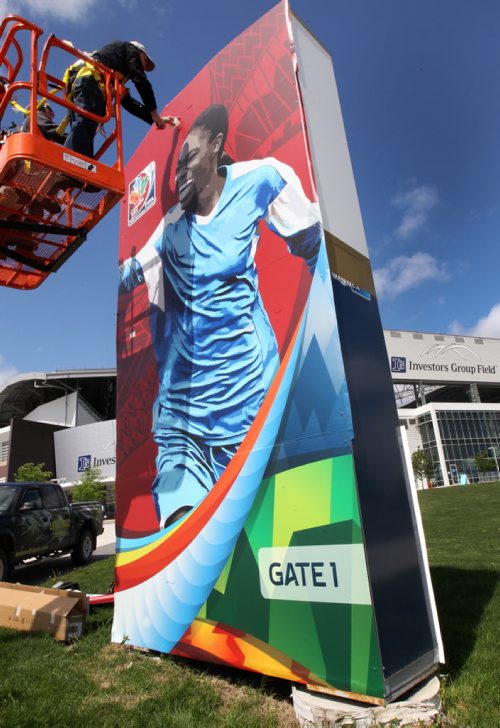FIFA Womens World Cup banners going up outside of Investors Group Field Friday afternoon in Winnipeg-See Melissa Martin story- May 29, 2015   (JOE BRYKSA / WINNIPEG FREE PRESS)