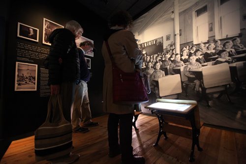Museum goers examine the  Childhood Denied, Indian Residential Schools and their Legacy exhibit in the Canadian Journey's Gallery at the Canadian Museum for Human Rights.  See story on Truth and Reconciliation Conference report.   May 28, 2015 Ruth Bonneville / Winnipeg Free Press