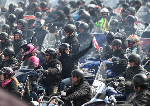 A women waves to someone in the crowd as over 1,600 motorcycles revved up their engines in unison in the Polo Park parking lot just before heading out for the annual Ride for Dad to raise funds for prostate cancer Saturday morning,     May 30, 2015 Ruth Bonneville / Winnipeg Free Press