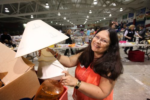 Ana Herntier holds a lamp with a sailboat theme at Herntier family garage garage sale Saturday at the St. Andrew CC.  Sale  runs through till 5 Sunday. See Alex Paul story.   May 30, 2015 Ruth Bonneville / Winnipeg Free Press