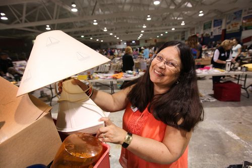 Ana Herntier holds a lamp with a sailboat theme at Herntier family garage sale Saturday at the St. Andrew CC.  Sale  runs through till 5 Sunday. See Alex Paul story.   May 30, 2015 Ruth Bonneville / Winnipeg Free Press
