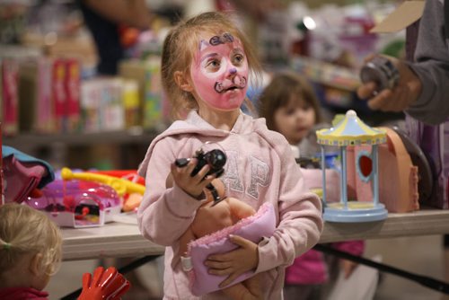 Six-year-old Avalea Leiss checks out some toys at the Herntier family garage sale at the St. Andrew CC Saturday afternoon which runs through till 5 Sunday. See Alex Paul story.   May 30, 2015 Ruth Bonneville / Winnipeg Free Press