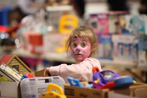Six-year-old Avalea Leiss checks out some toys at the Herntier family garage sale at the St. Andrew CC Saturday afternoon which runs through till 5 Sunday. See Alex Paul story.   May 30, 2015 Ruth Bonneville / Winnipeg Free Press