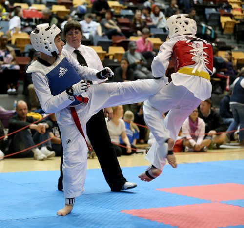Daniel Shteinbook kicks Gabriel Semeniuk during the 12 and 13 year old Advanced Medium sparring at the Iron Fist Taekwondo Club Challenge at the University of Manitoba, Saturday, May 30, 2015. (TREVOR HAGAN/WINNIPEG FREE PRESS)