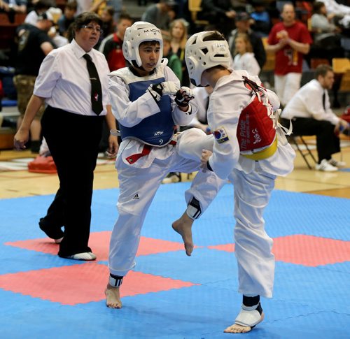 Daniel Shteinbook and Gabriel Semeniuk during the 12 and 13 year old Advanced Medium sparring at the Iron Fist Taekwondo Club Challenge at the University of Manitoba, Saturday, May 30, 2015. (TREVOR HAGAN/WINNIPEG FREE PRESS)