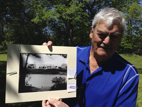 Bob LaFleche, 76, holds a photo of the St. Charles ferry crossing the Assiniboine River carrying his family's 1953 Ford. LaFleche grew up in Caron House next to the ferry crossing and returned there for Doors Open Winnipeg Sunday. May 31, 2015. (CAROL SANDERS / WINNIPEG FREE PRESS)