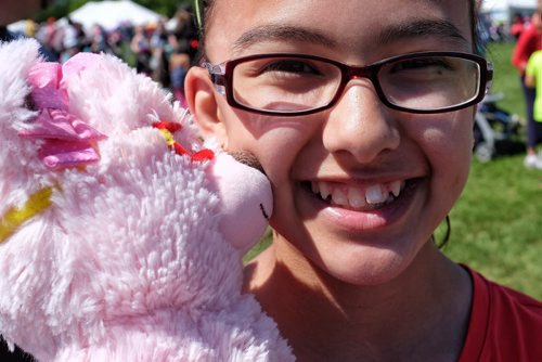 Emily Manabat, 12, with her teddy bear at the Teddy Bears' Picnic at Assiniboine Park. The event brings around 30,000 people to the park, mostly kids with their stuffed toys that are damaged and need fixing. The money raised goes towards the Childrens Hospital Foundation of Manitoba.  150531 May 31, 2015 Mike Deal / Winnipeg Free Press