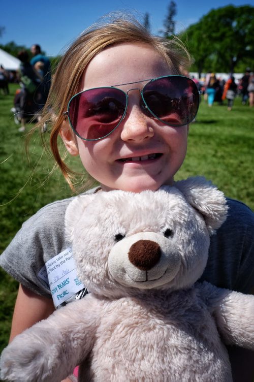 Hayley Doig, 7, with her teddy bear at the Teddy Bears' Picnic at Assiniboine Park. The event brings around 30,000 people to the park, mostly kids with their stuffed toys that are damaged and need fixing. The money raised goes towards the Childrens Hospital Foundation of Manitoba.  150531 May 31, 2015 Mike Deal / Winnipeg Free Press