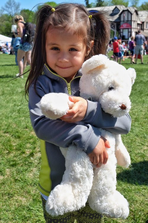 Sophie Uta, 4, with her teddy bear at the Teddy Bears' Picnic at Assiniboine Park. The event brings around 30,000 people to the park, mostly kids with their stuffed toys that are damaged and need fixing. The money raised goes towards the Childrens Hospital Foundation of Manitoba.  150531 May 31, 2015 Mike Deal / Winnipeg Free Press