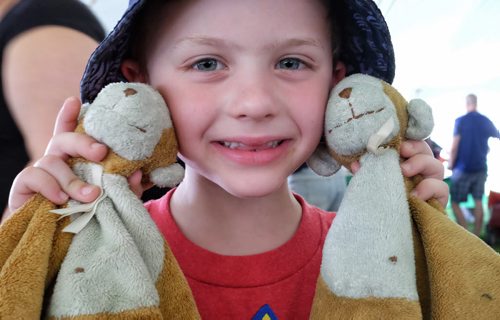 Carson Jaworski, 6, with his sad monkey (left) and happy monkey (right) at the Teddy Bears' Picnic at Assiniboine Park. The event brings around 30,000 people to the park, mostly kids with their stuffed toys that are damaged and need fixing. The money raised goes towards the Childrens Hospital Foundation of Manitoba.  150531 May 31, 2015 Mike Deal / Winnipeg Free Press